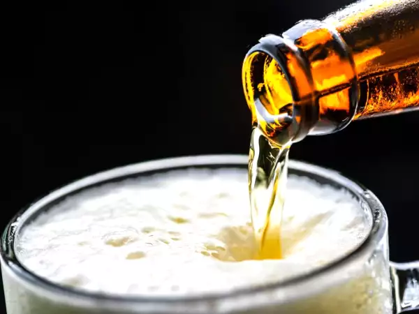 Warum schäumt Bier weniger, wenn man das Glas kippt?