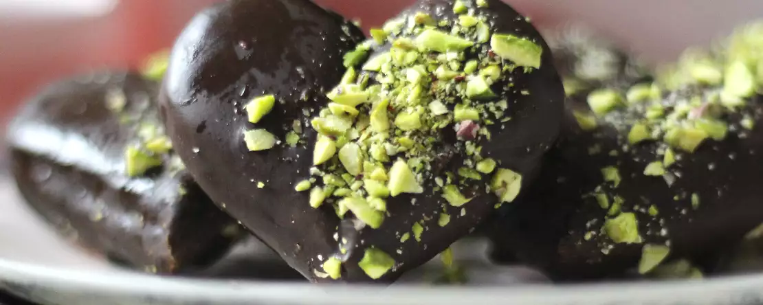 Soletilla-herzen mit schokoladen- und pistazienüberzug